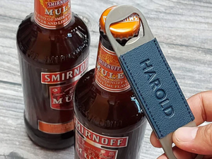 Bottle opener with leather sleeves
